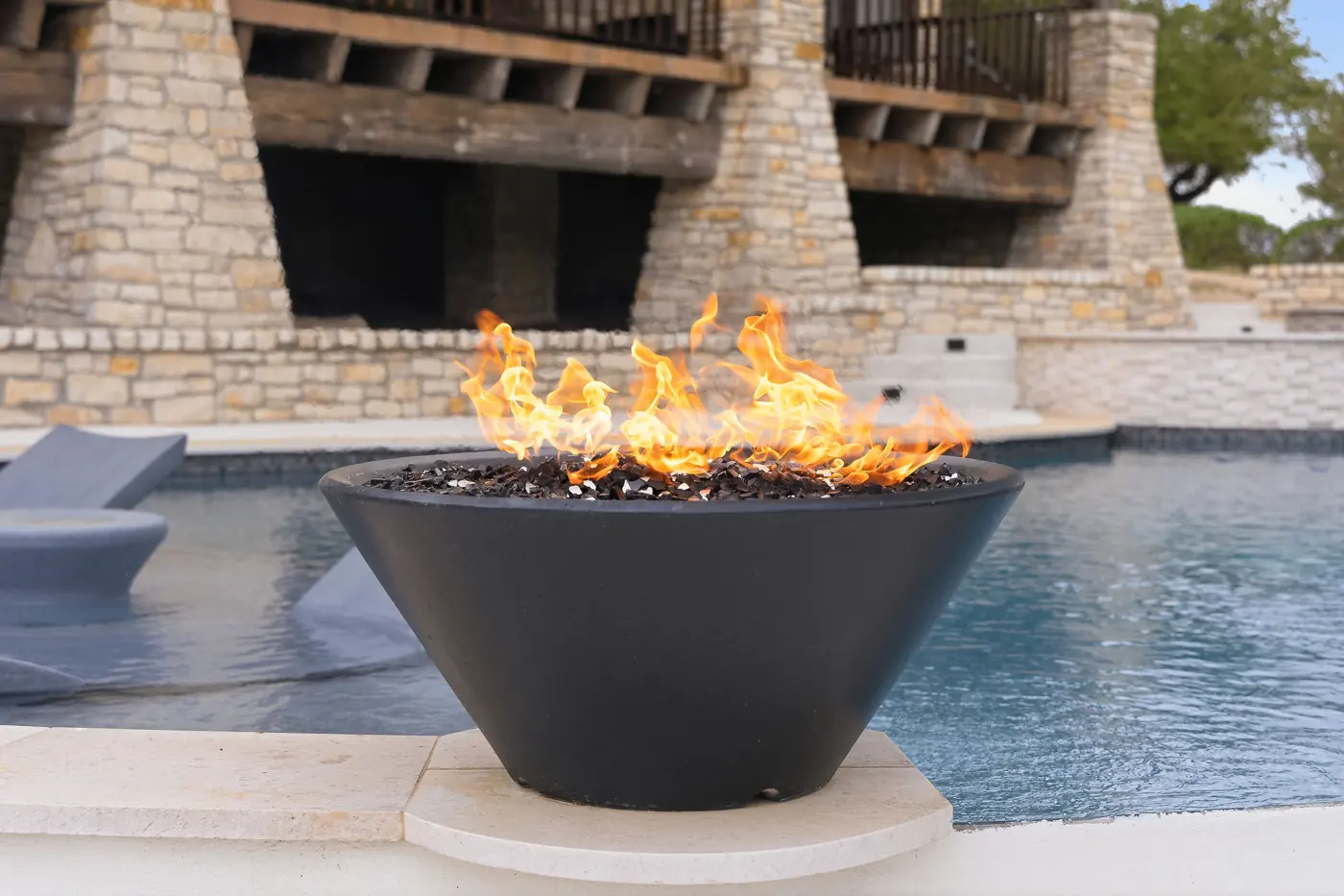 Fire bowl water feature at a pool restored by our team
