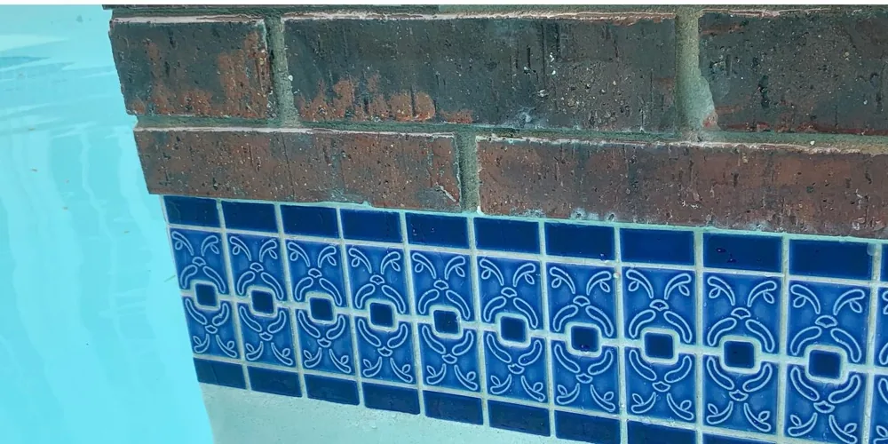 After: vivid Talavera-pattern tile with clean brick coping