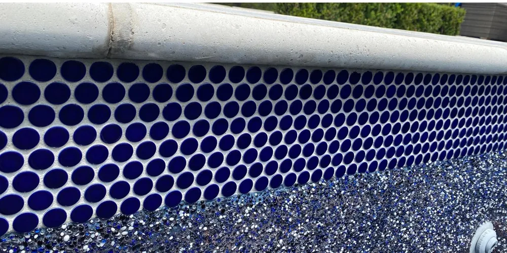 After: crisp navy penny-round waterline tile