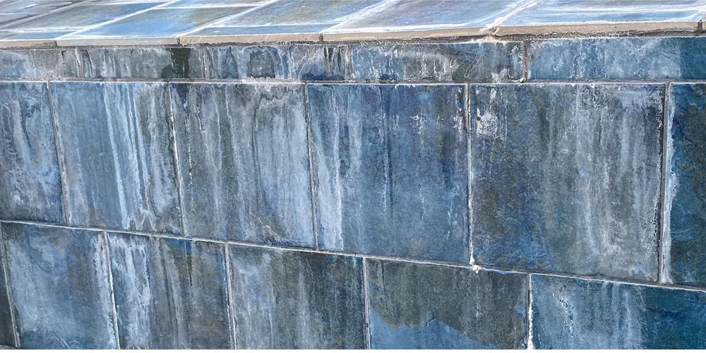 Before: blue slate-look tile clouded with calcium scale