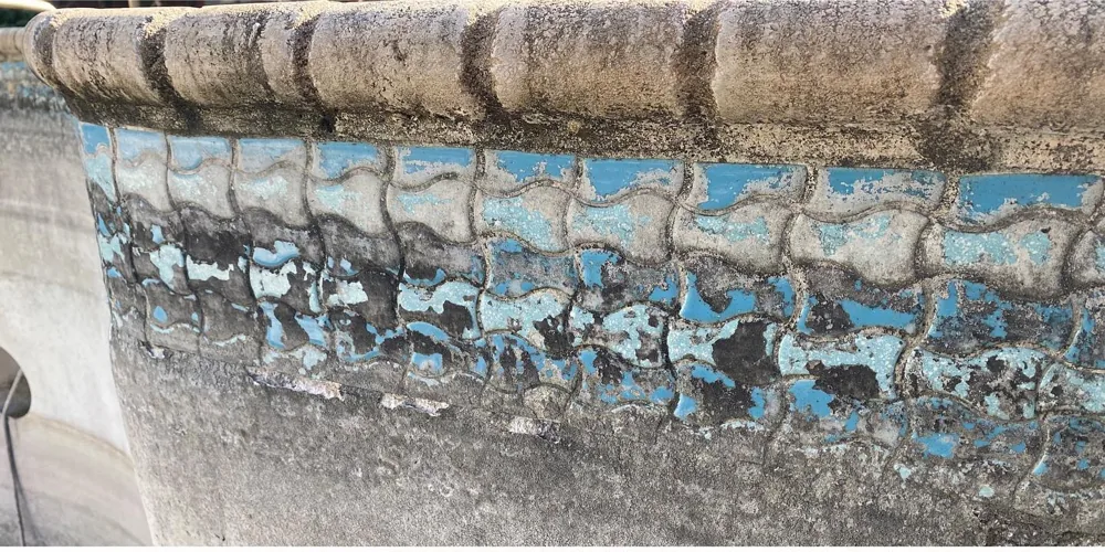 Before: turquoise wave-pattern tile with heavy dark staining