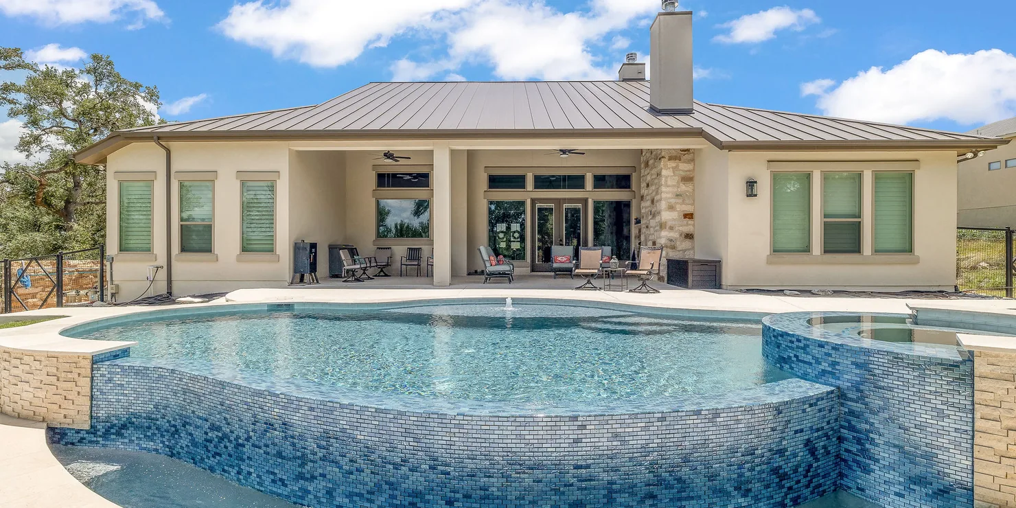Renovated backyard pool with covered patio and mountain view on a sunny day