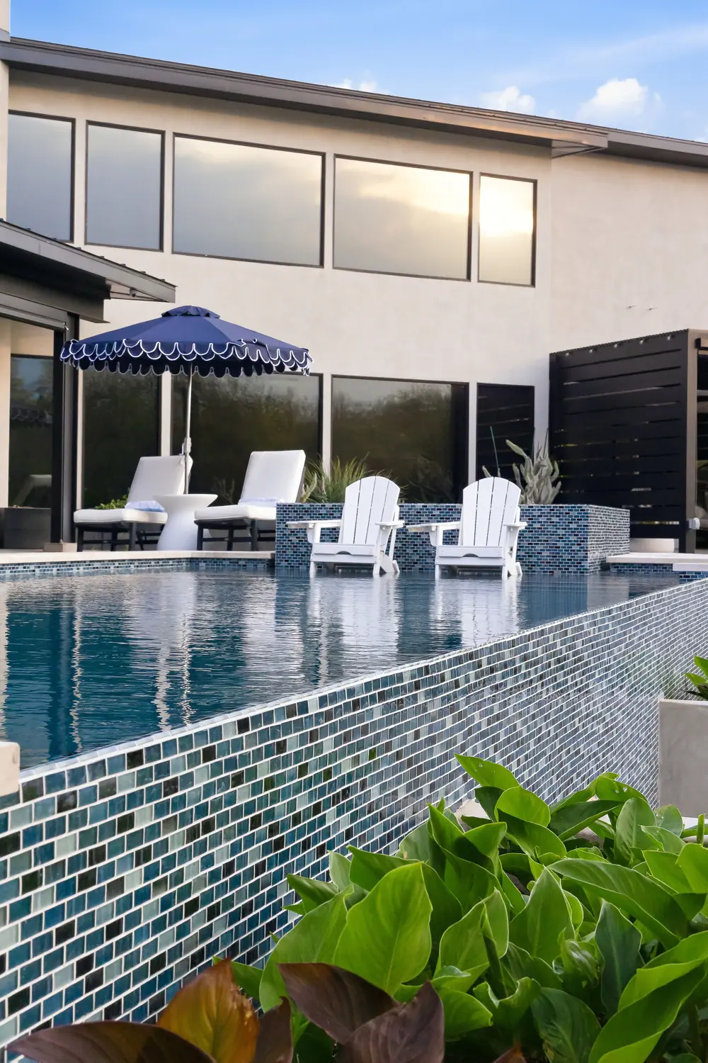 Modern pool courtyard with serviced equipment and umbrella seating