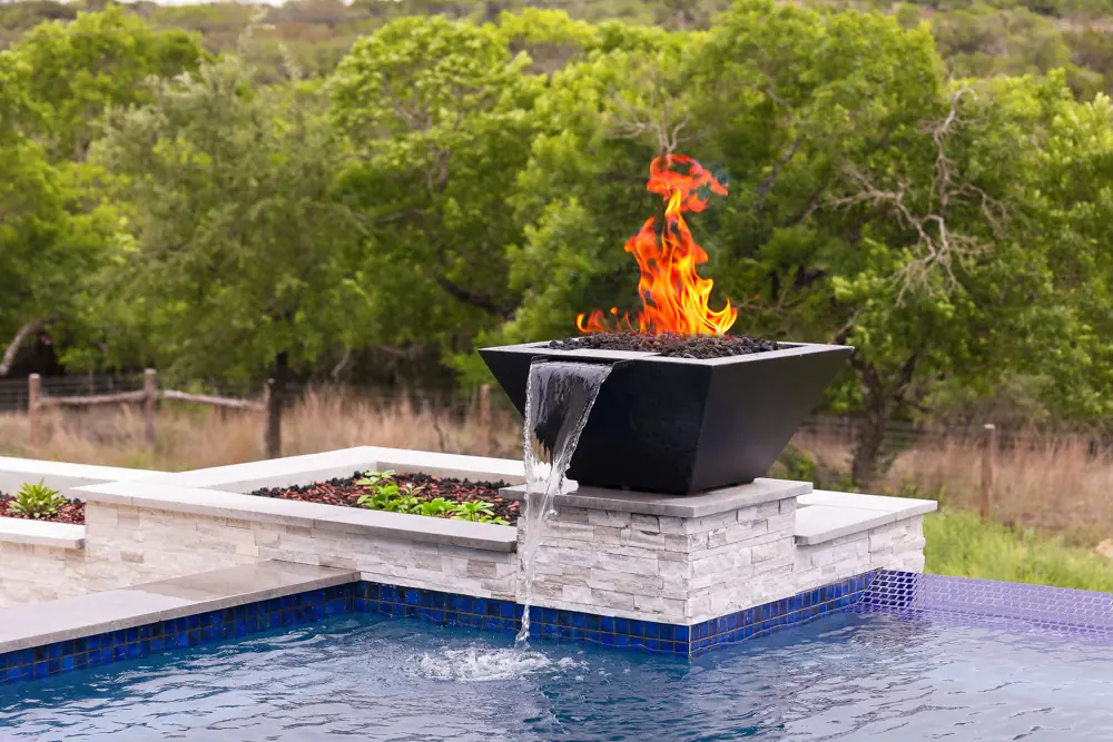 Fire bowl water feature with serviced plumbing at a Hill Country pool