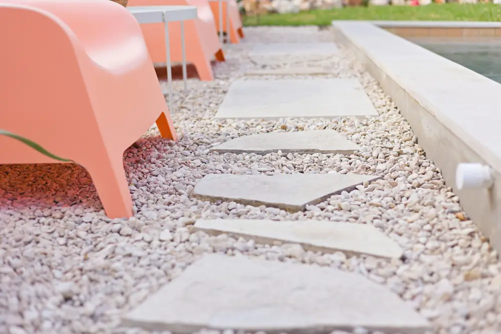 Pool deck and stepping pads beside a smooth, repaired pool surface