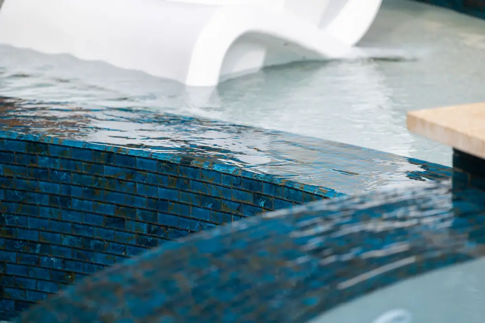 Blue tile detail at a repaired fiberglass pool