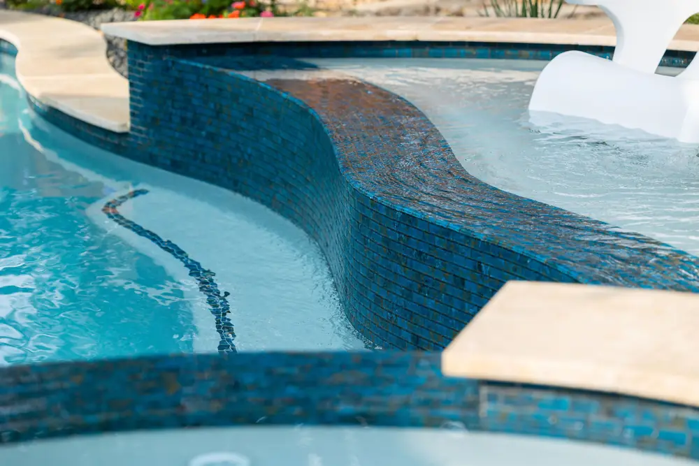 Curved tile wall detail at a repaired fiberglass pool