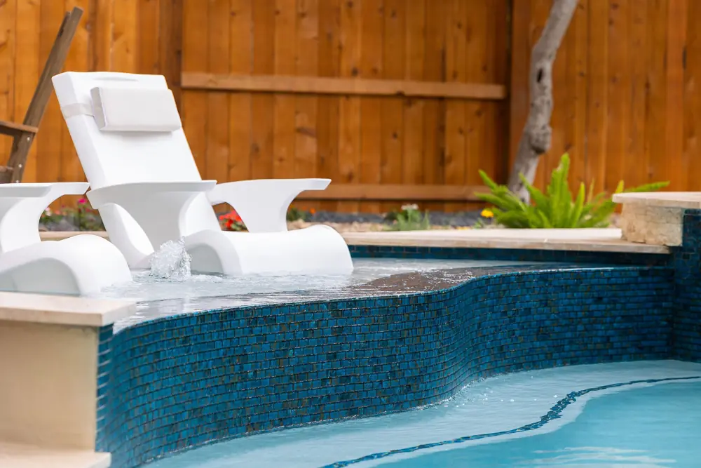White loungers in a spa at a repaired fiberglass pool