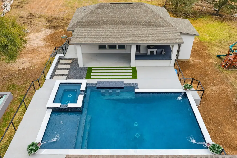 Aerial view of a spa and pool with a repaired waterline
