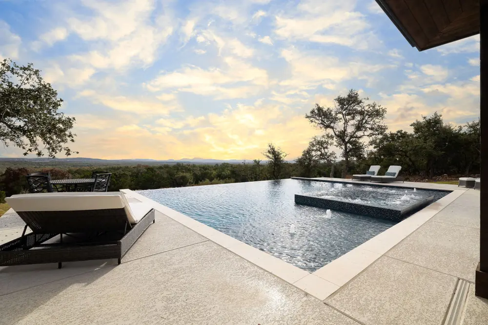 Sunset view of a repaired infinity pool and spa