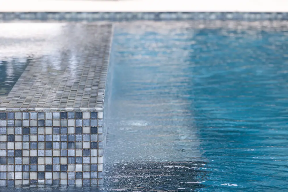 Tile corner detail with blurred pool water