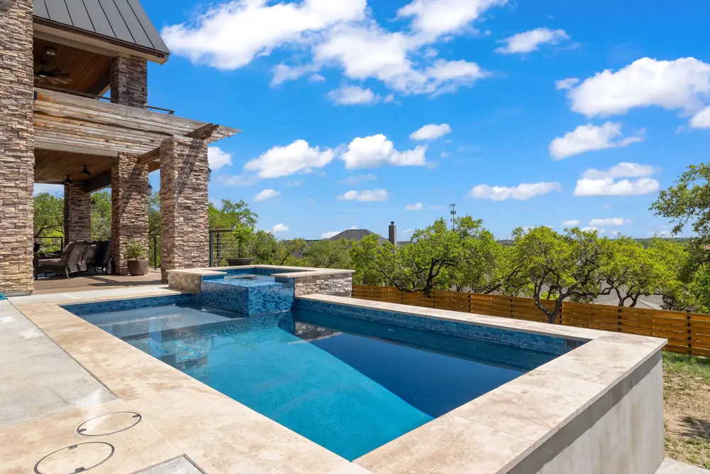 Repaired blue tile spillway pool at a Hill Country stone home