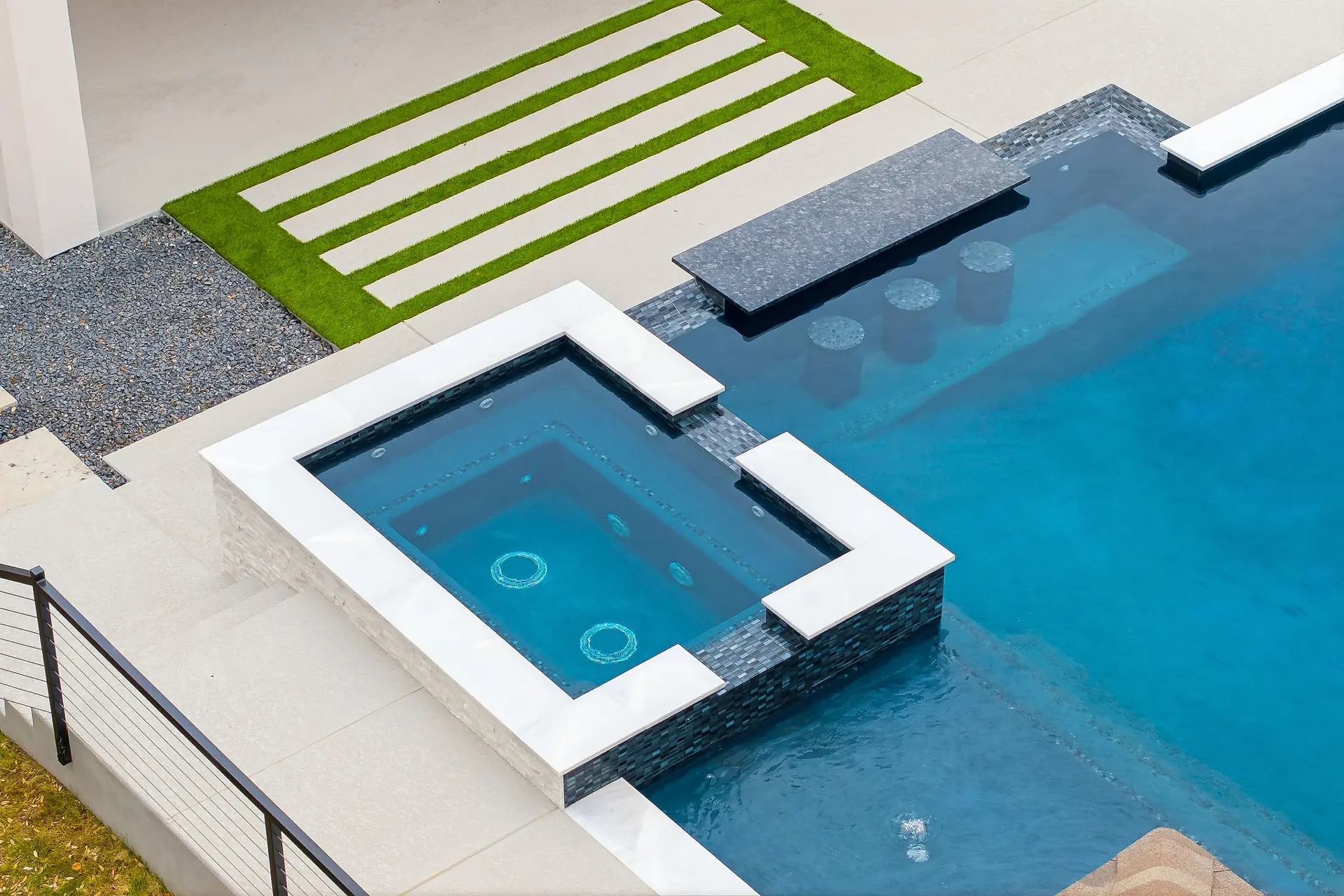Aerial view of a geometric pool and spa near New Braunfels