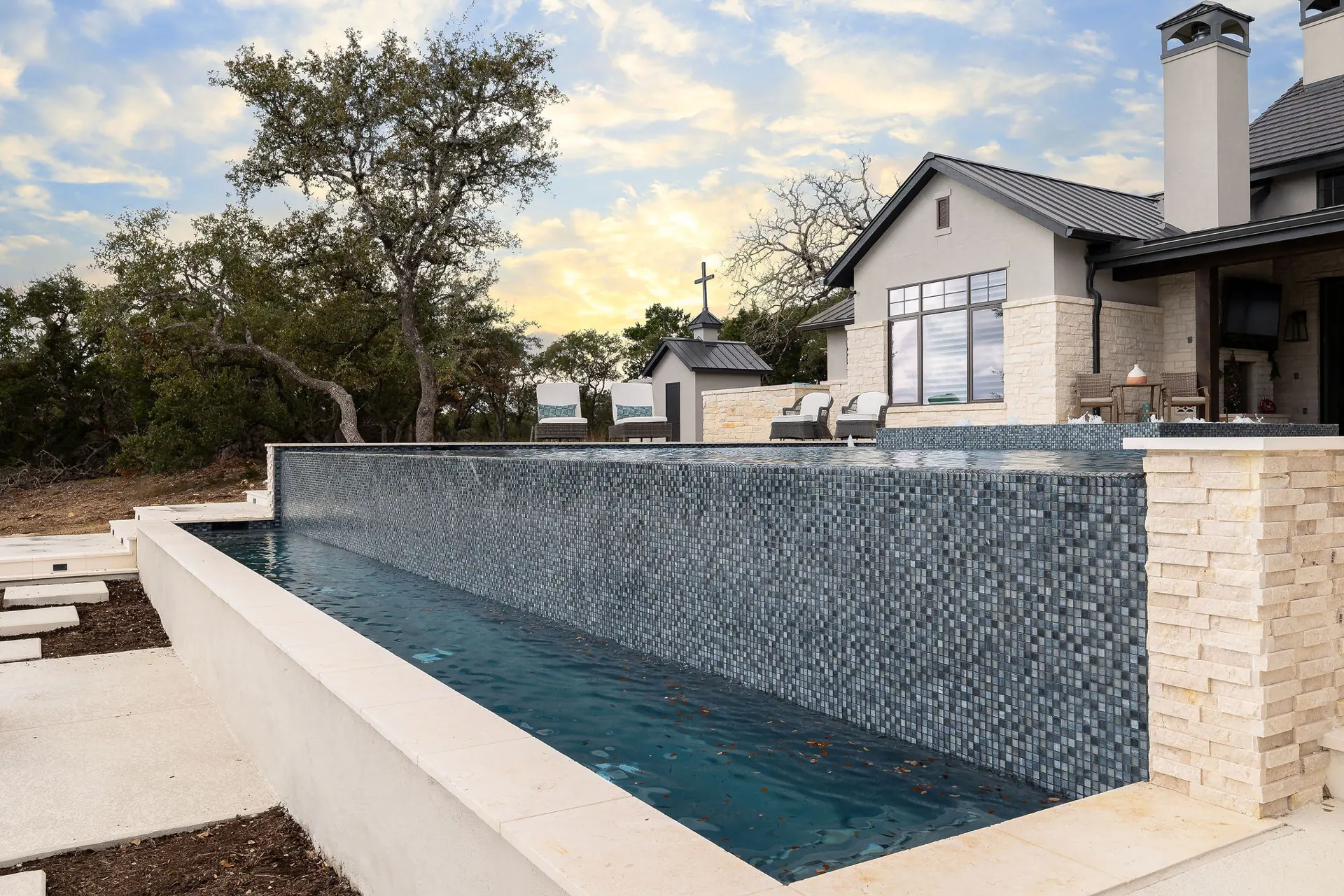 Pool and tile spillway wall at a Texas Hill Country home near San Antonio