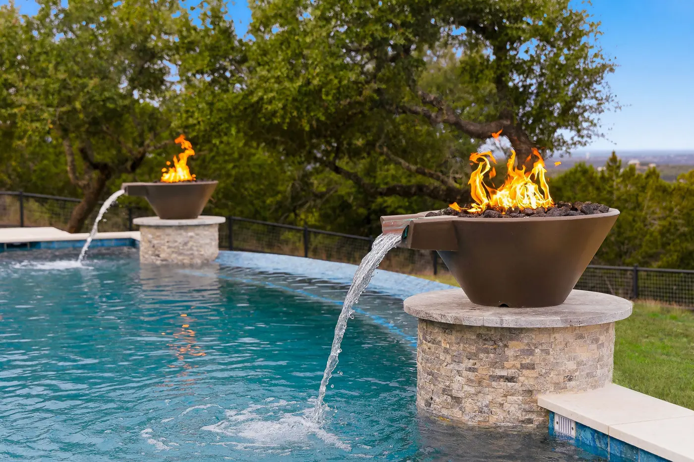 Custom pool with fire and water bowl features built and serviced by the same local team