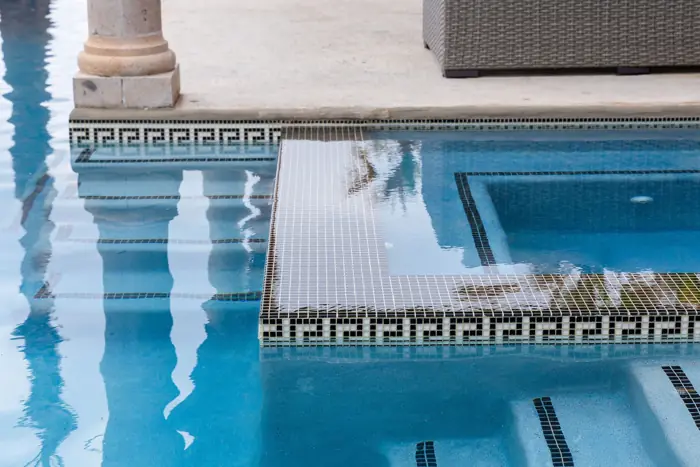 Decorative waterline tile repaired and matched to the pool