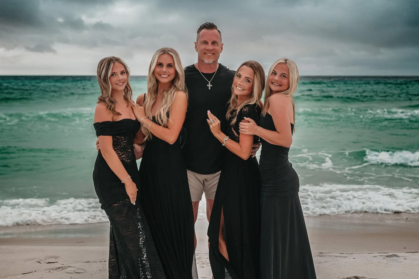 Wayne Lunsford with his wife Amber and their three daughters on the beach