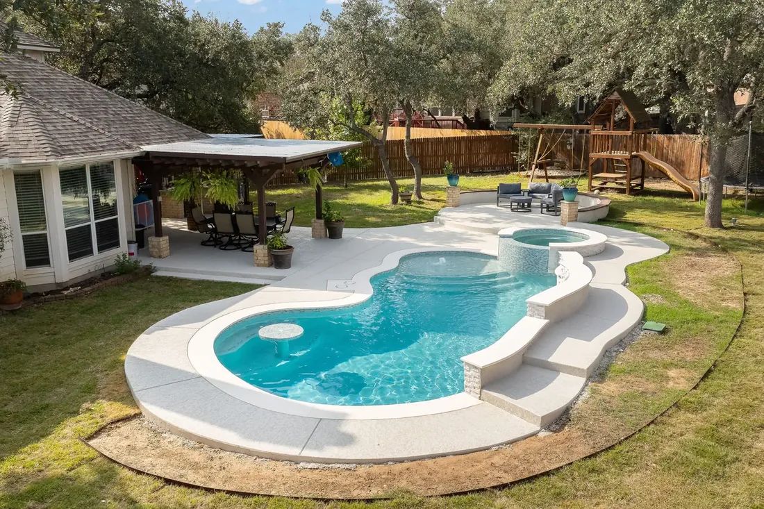 Renovated backyard pool with modern landscaping