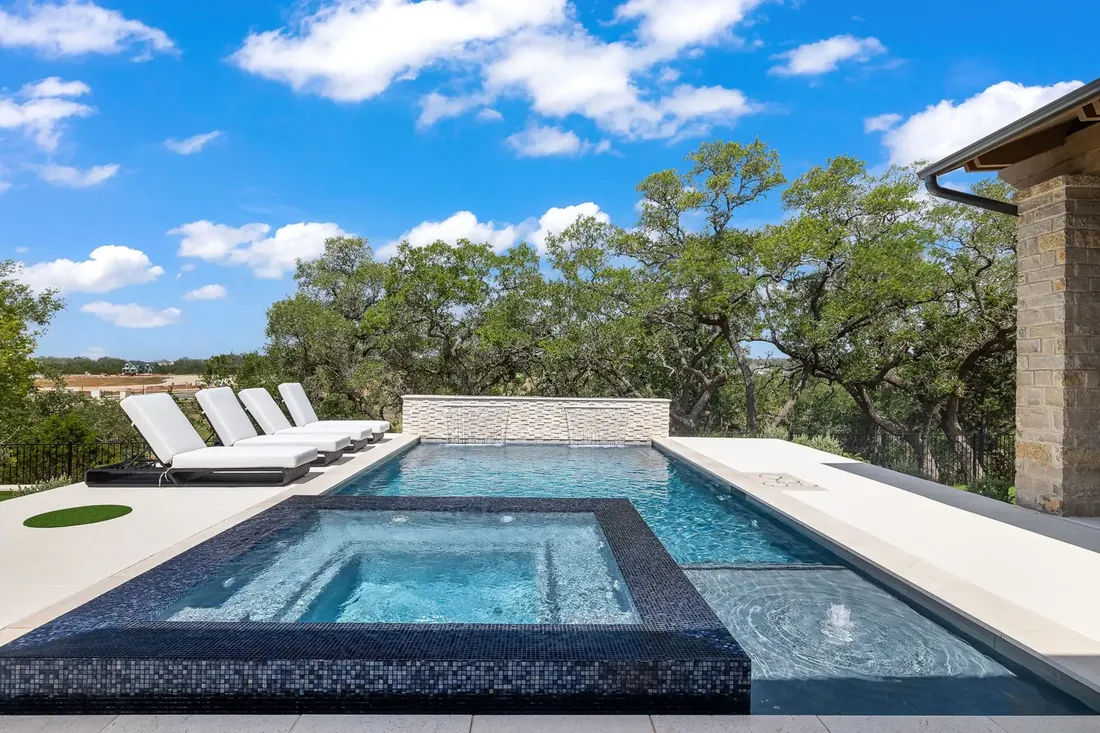 Sunlit backyard pool at a Hill Country home